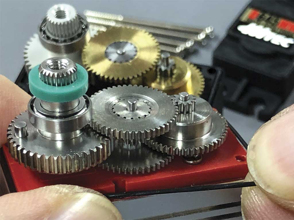 Close up of a ProModeler servo gear train with Hitec servo in the background slightly out of focus