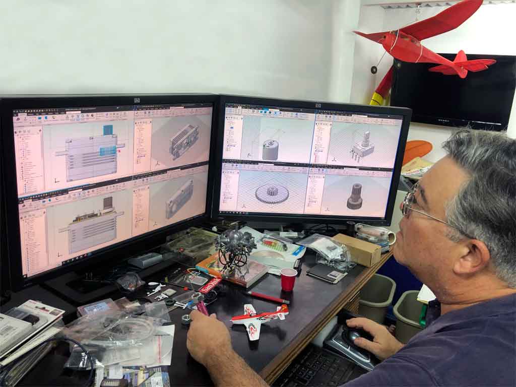 Close up photo of engineer peering at computer monitor while designing a serv on on a workstation