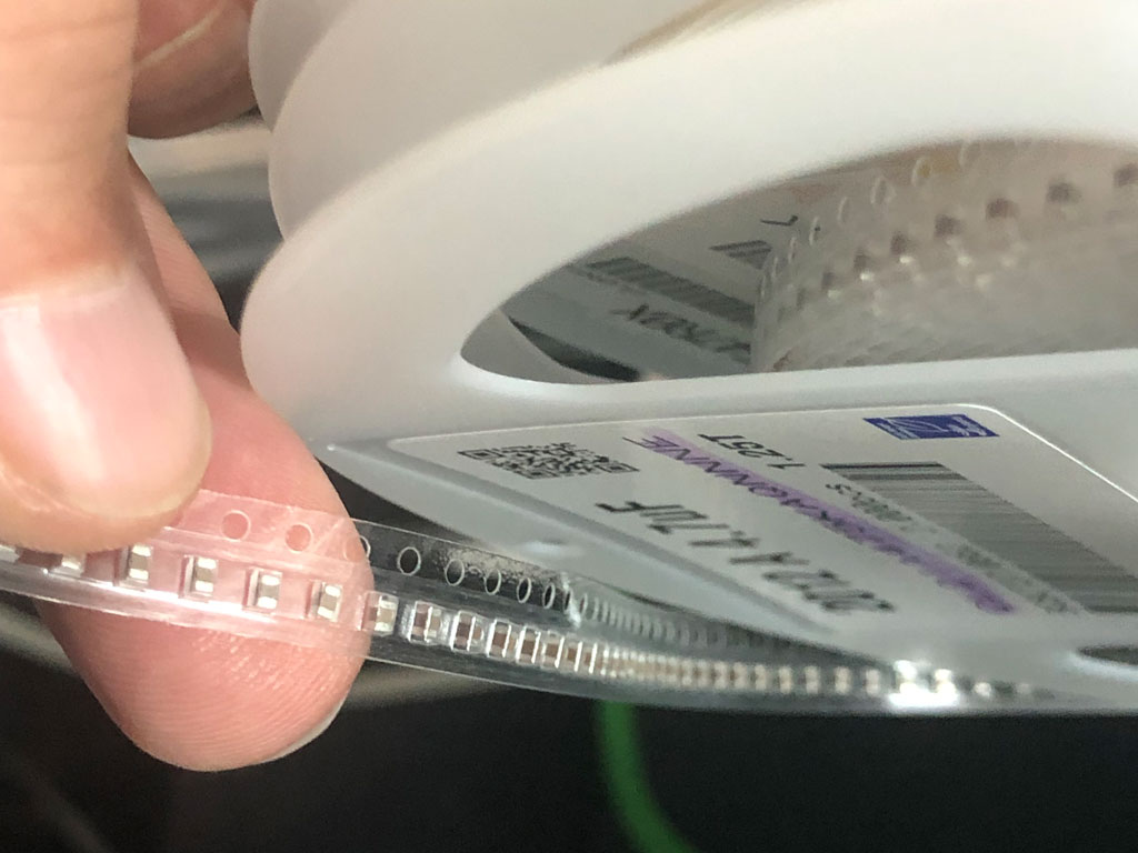 Close up photo of electronic components mounted to a tape