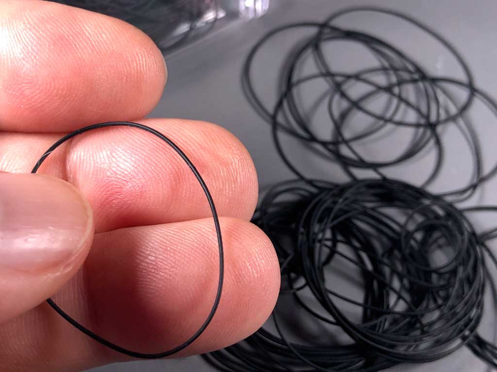close up of fingers holding custom o-rings for sealing between ProModeler case sections